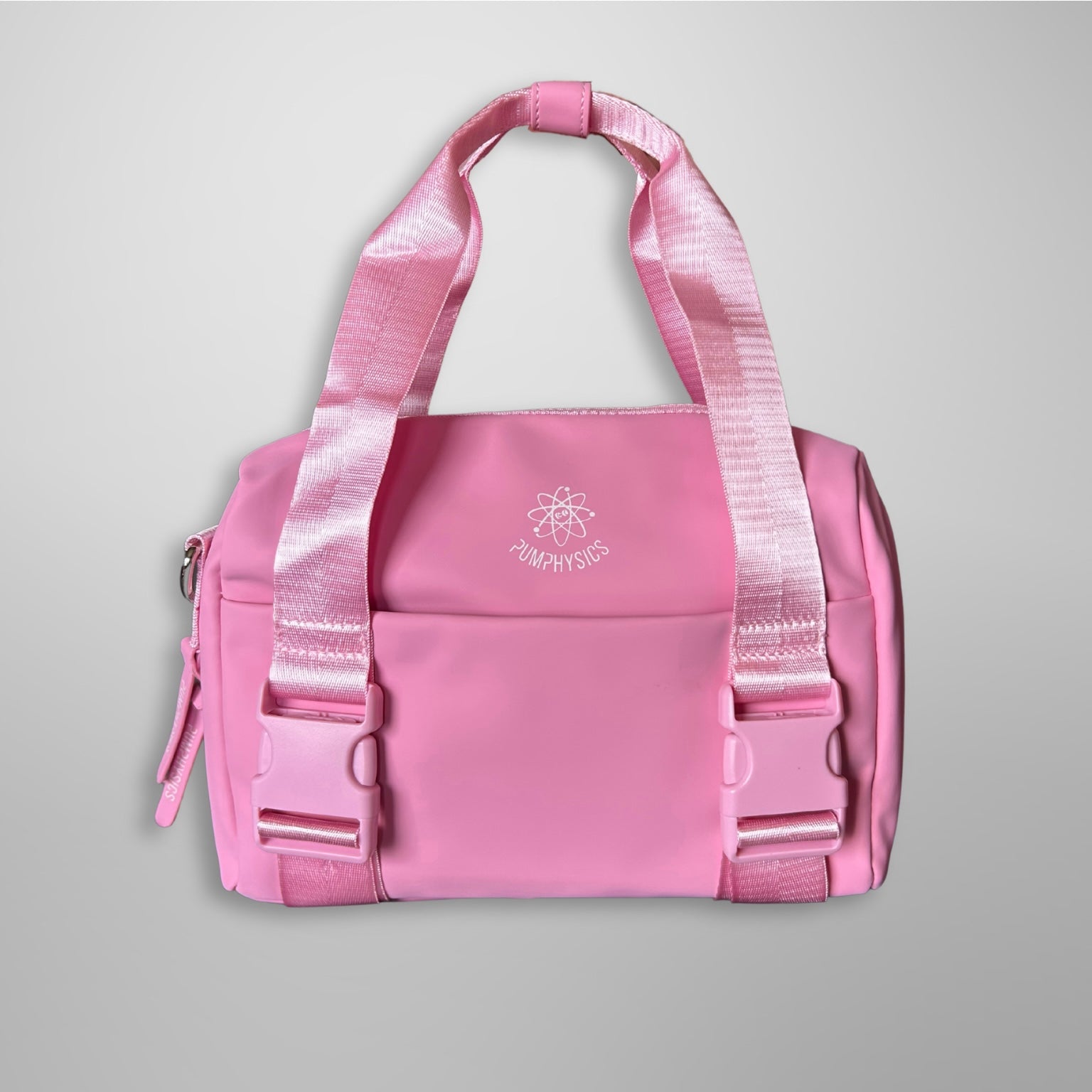 Pink duffel bag with a visible brand logo on a gray background